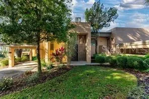 a view of a house with a yard and tree s