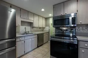 a kitchen with a sink stove and microwave
