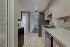 a kitchen with a sink and a refrigerator