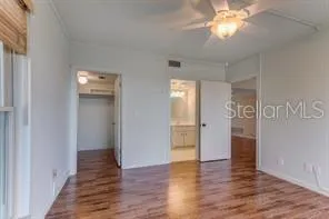 a view of empty room with wooden floor