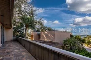 a view of a balcony with wooden fence