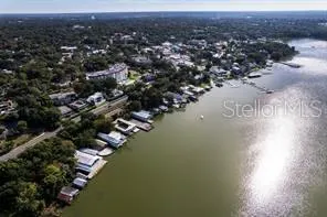 an aerial view of a house with a lake view