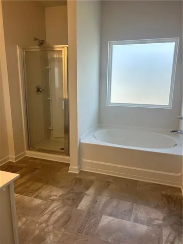 a bathroom with a bathtub and a shower