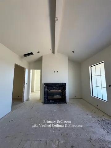 a view of empty room with a fireplace