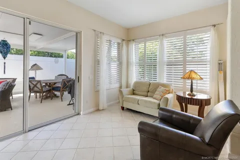 a bedroom with a bed window and a table
