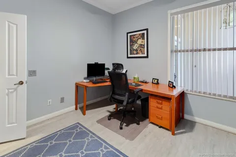 a view of bathroom with a shower and a window