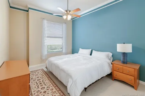 a kitchen with white cabinets and sink