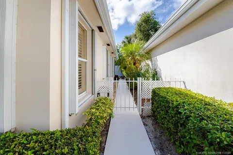 a dining room with furniture and a potted plant