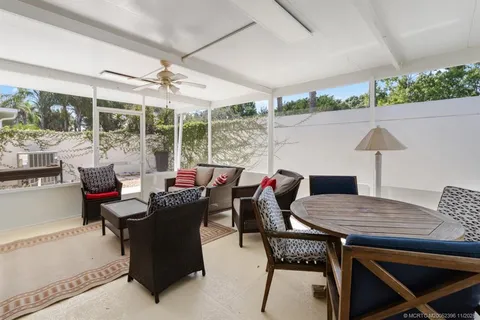 a view of a house with a yard and potted plants