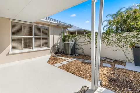 an aerial view of a house with garden space and street view