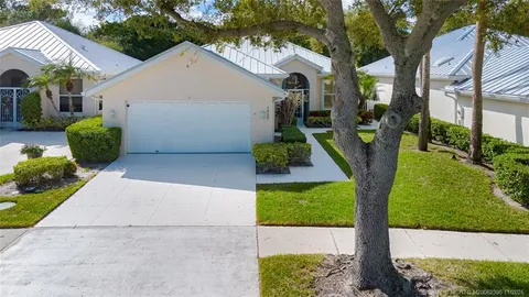 an aerial view of a house with garden space and street view