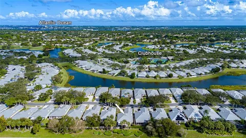 an aerial view of a house with a garden and lake view