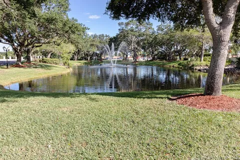 a view of a patio with a table and chairs under an umbrella