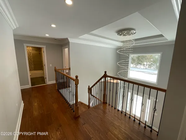 a large space with wooden floor and ceiling fan