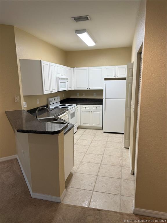 225 Southeast Kitching Circle Stuart, FL 34994 - Photo 14 of 24 a kitchen with a sink appliances and cabinets