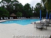 225 Southeast Kitching Circle Stuart, FL 34994 - Photo 5 of 24 a view of a swimming pool with a patio