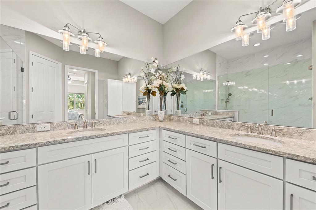 295 Compass Point Drive, Unit 202 Bradenton, FL 34209 - Photo 26 of 100 a bathroom with a sink vanity granite and a mirror