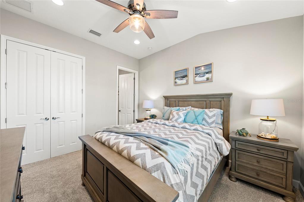 295 Compass Point Drive, Unit 202 Bradenton, FL 34209 - Photo 36 of 100 a bedroom with a bed and a chandelier