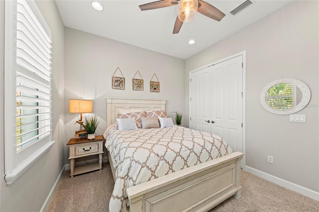 295 Compass Point Drive, Unit 202 Bradenton, FL 34209 - Photo 38 of 100 a bedroom with a bed and a window