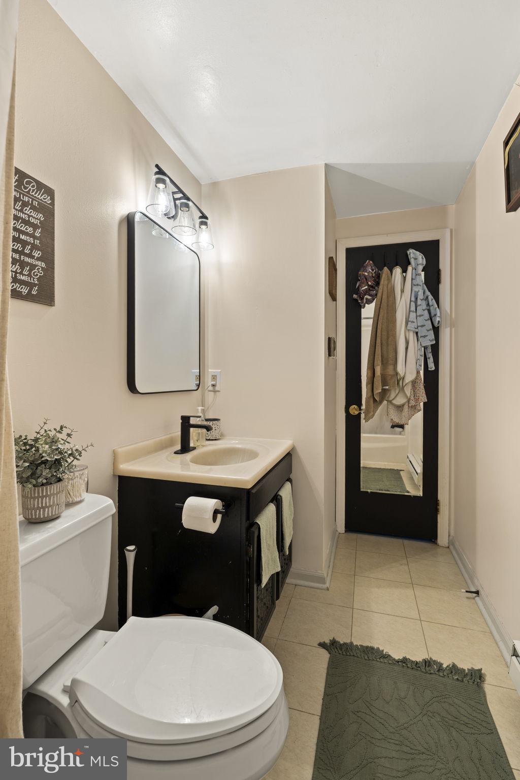 1165 Stellar Drive Mount Joy, PA 17552 - Photo 19 of 37 a bathroom with a toilet a sink a mirror and vanity