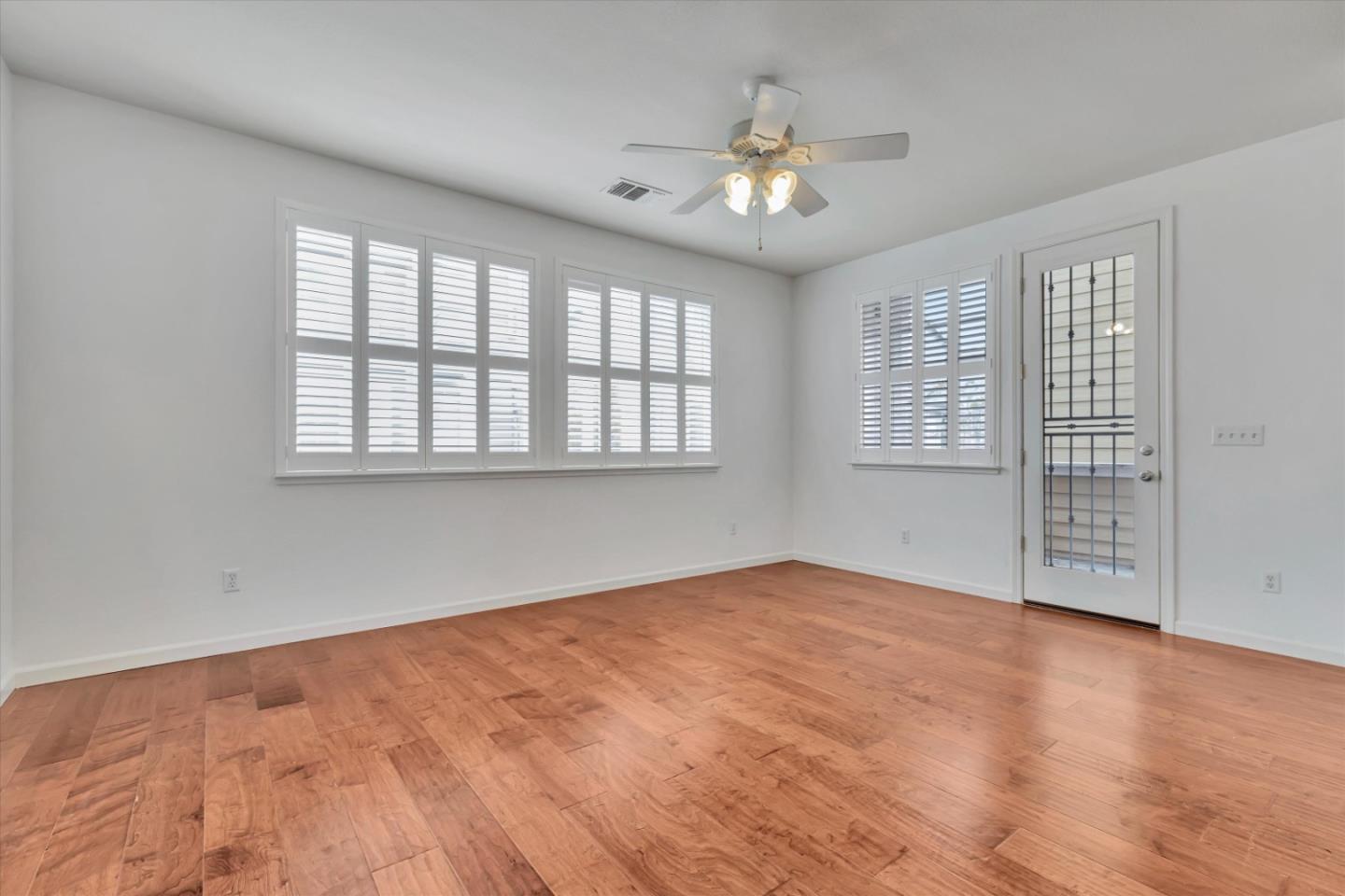 5175 Trinity Park Drive Alviso, CA 95002 - Photo 12 of 24 an empty room with chandelier fan and windows
