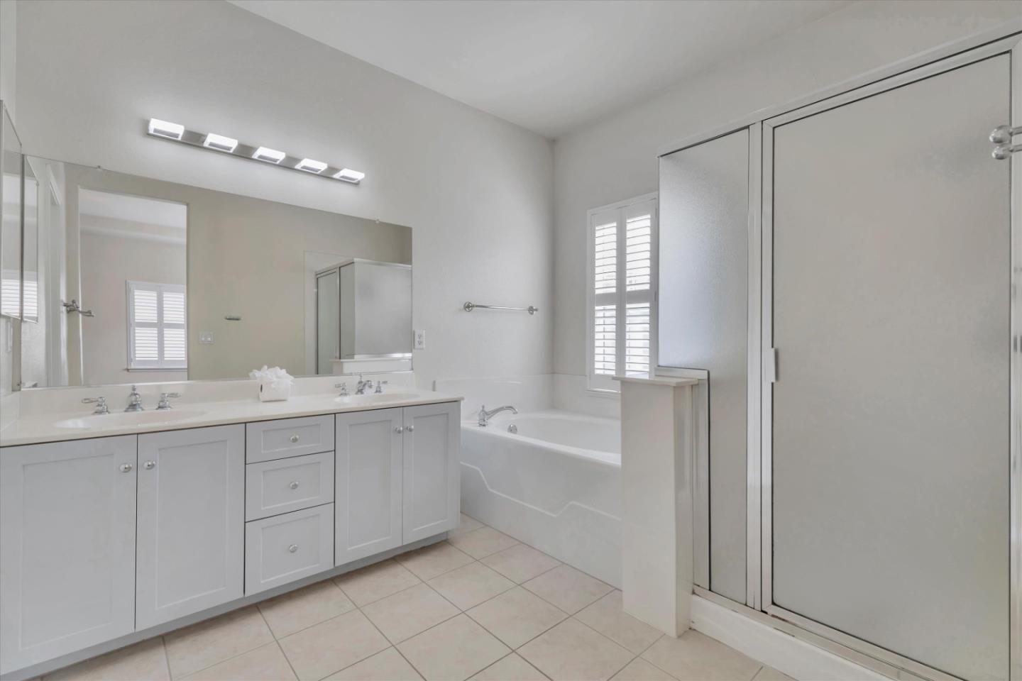 5175 Trinity Park Drive Alviso, CA 95002 - Photo 18 of 24 a spacious bathroom with a double vanity sink mirror and bathtub