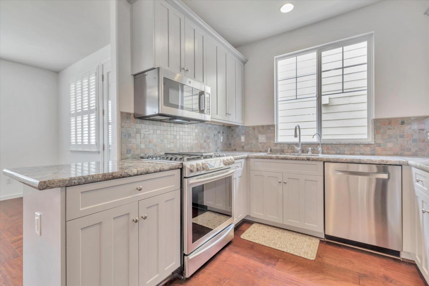 5175 Trinity Park Drive Alviso, CA 95002 - Photo 7 of 24 a kitchen with granite countertop white cabinets and white appliances