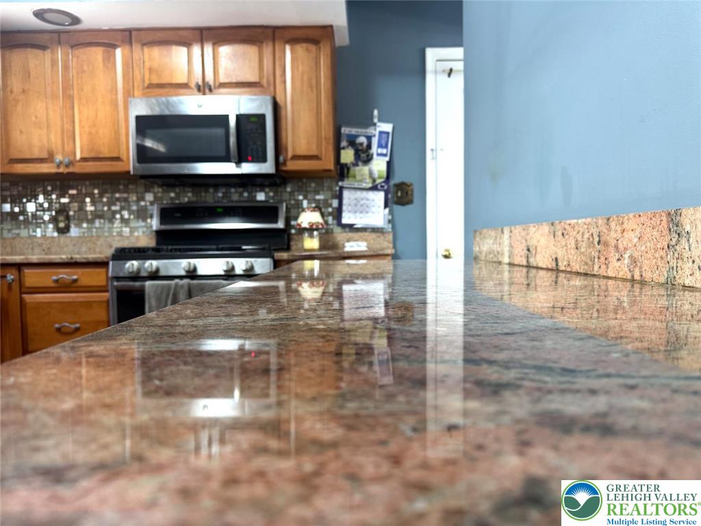 9 Jewel Street Roseto, PA 18013 - Photo 15 of 25 a kitchen with stainless steel appliances a stove a microwave and sink
