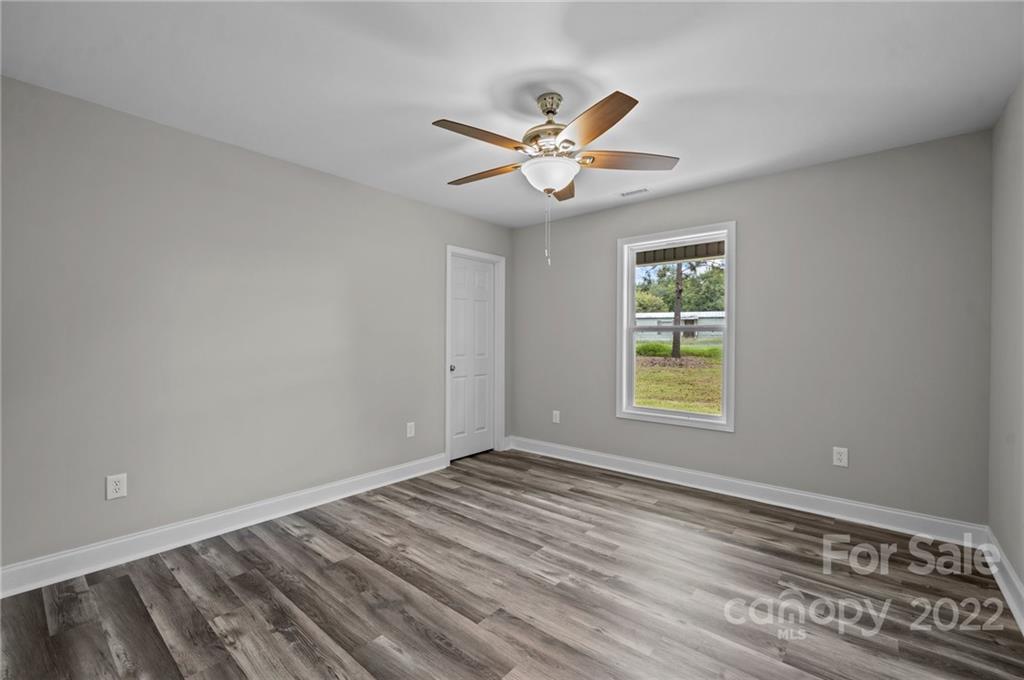 3840 Turner Road Clover, SC 29710 - Photo 13 of 28 a view of an empty room with wooden floor and a window