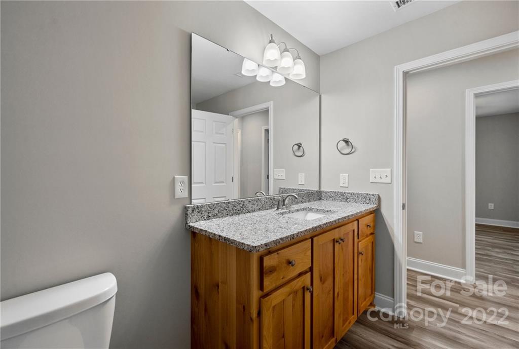 3840 Turner Road Clover, SC 29710 - Photo 14 of 28 a bathroom with a granite countertop sink a toilet and a mirror