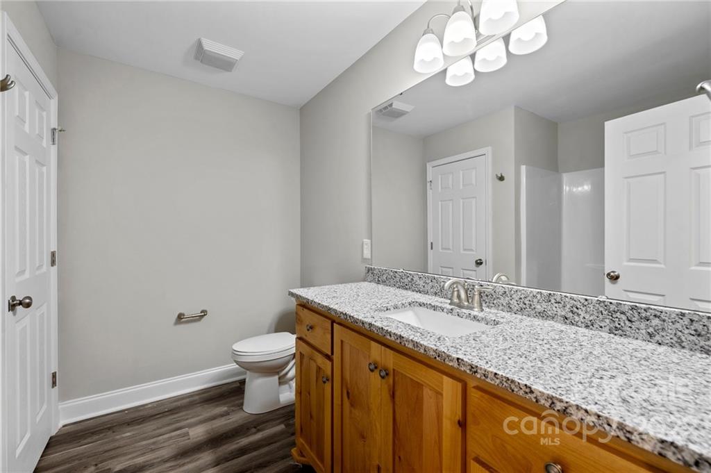 3840 Turner Road Clover, SC 29710 - Photo 15 of 28 a bathroom with a granite countertop sink a toilet and a mirror