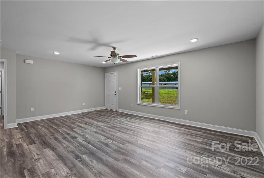 3840 Turner Road Clover, SC 29710 - Photo 17 of 28 a view of an empty room with a window and wooden floor