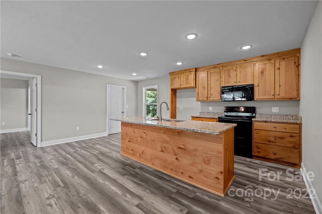 3840 Turner Road Clover, SC 29710 - Photo 18 of 28 a kitchen with granite countertop stainless steel appliances and wooden cabinets