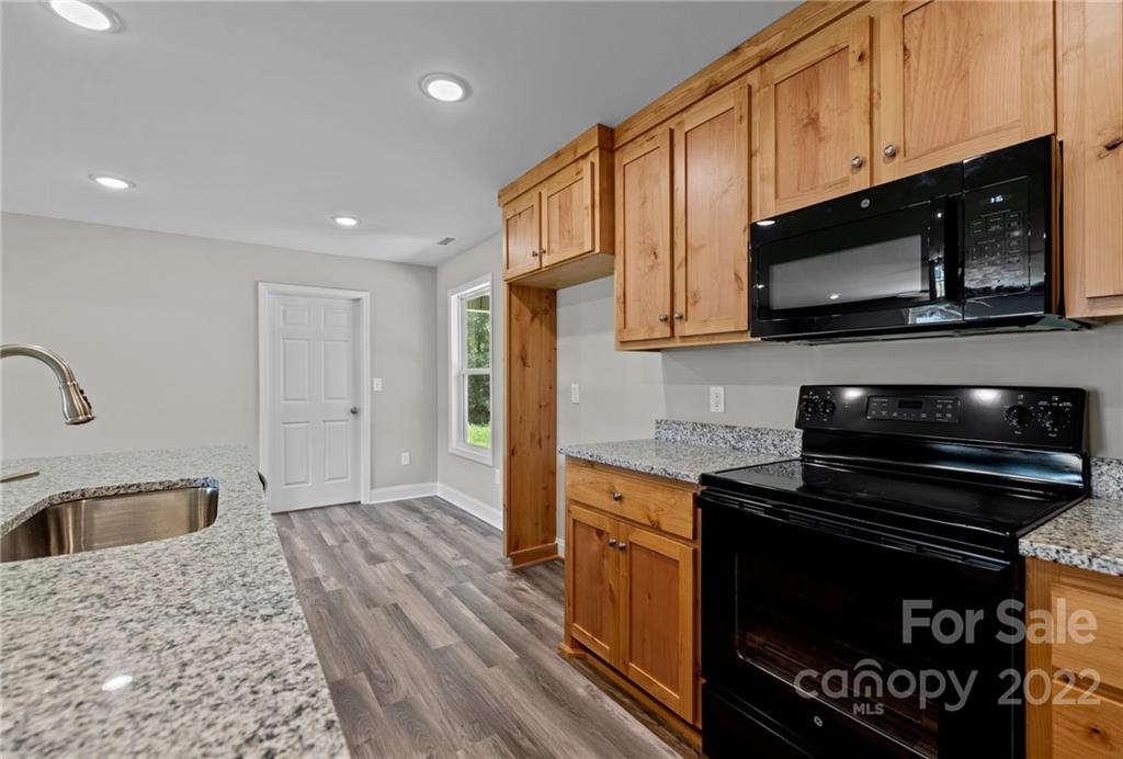 3840 Turner Road Clover, SC 29710 - Photo 20 of 28 a kitchen with stainless steel appliances wooden cabinets and a stove top oven
