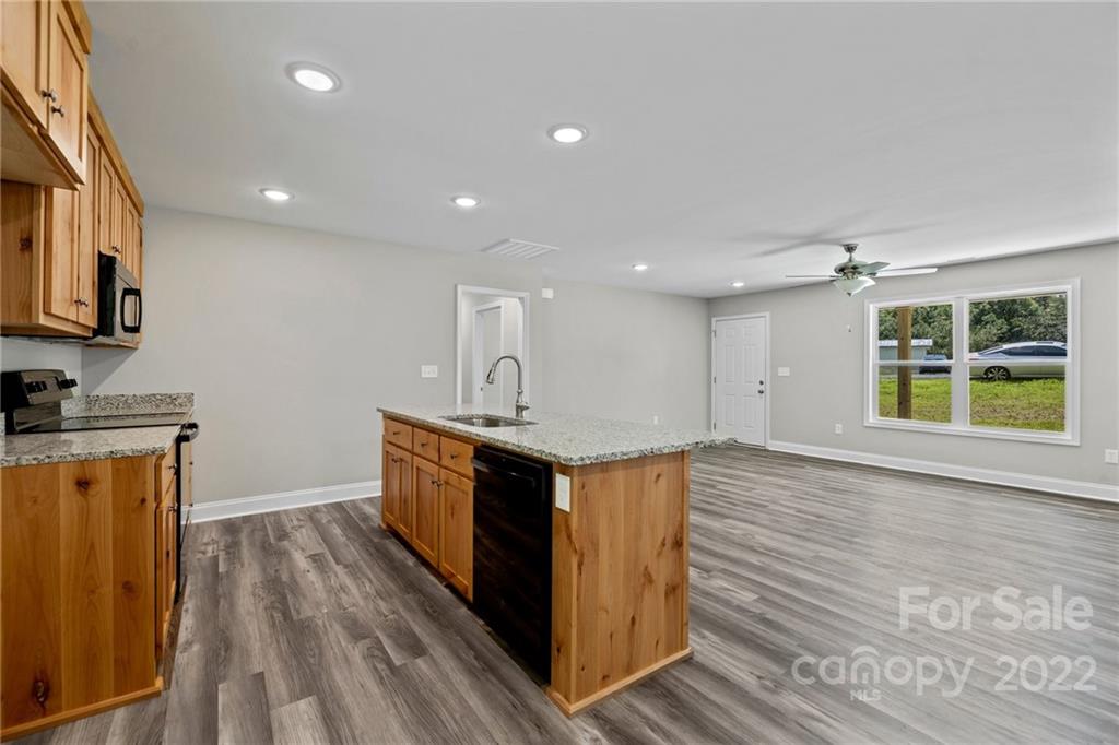 3840 Turner Road Clover, SC 29710 - Photo 21 of 28 a kitchen with stainless steel appliances granite countertop a stove a sink and a refrigerator
