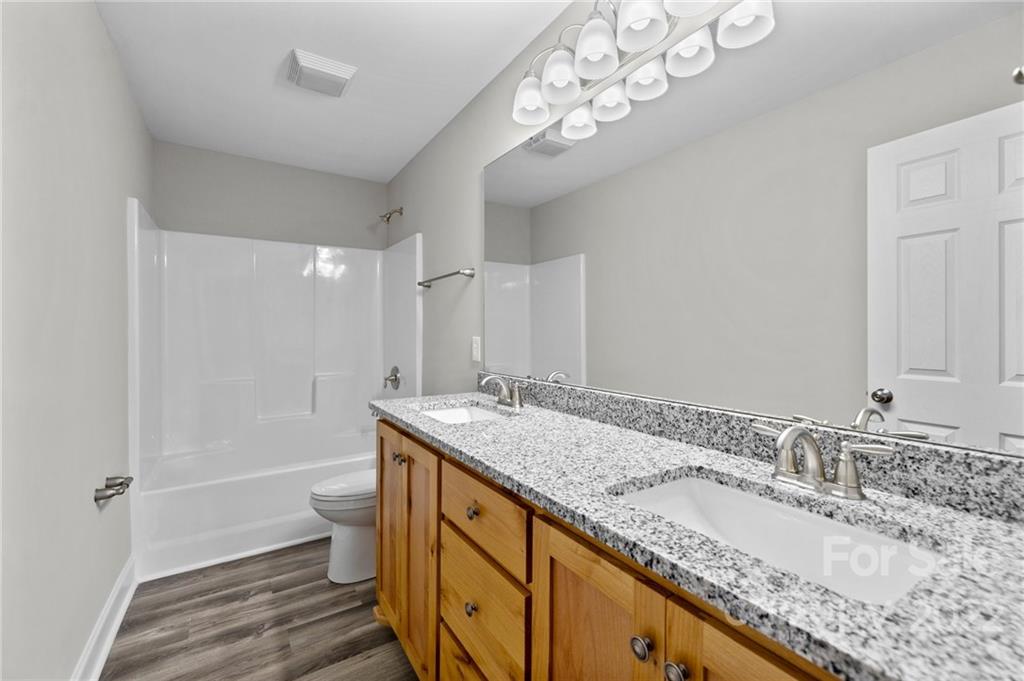 3840 Turner Road Clover, SC 29710 - Photo 23 of 28 a bathroom with a granite countertop double vanity sink and a mirror