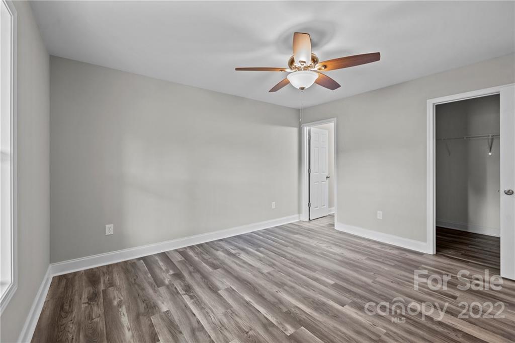 3840 Turner Road Clover, SC 29710 - Photo 24 of 28 a view of an empty room with wooden floor and a ceiling fan