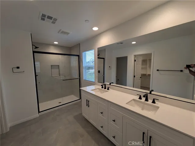 a bathroom with a shower and a glass door