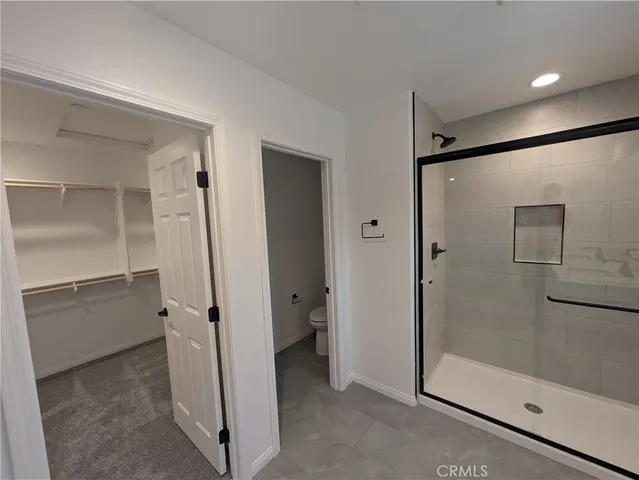 a bathroom with a glass shower door