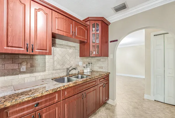 a kitchen with stainless steel appliances granite countertop a sink and a cabinets