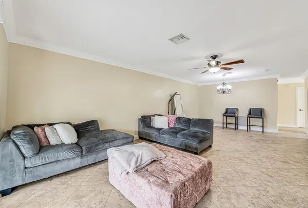 a living room with furniture and a chandelier