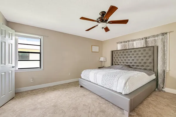 a bedroom with a bed and window