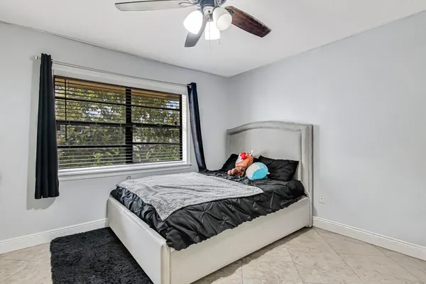 a bed sitting in a bedroom next to a window