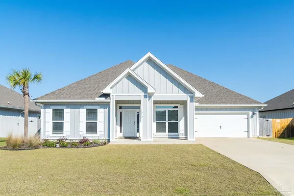 a view of a house with a yard and garage