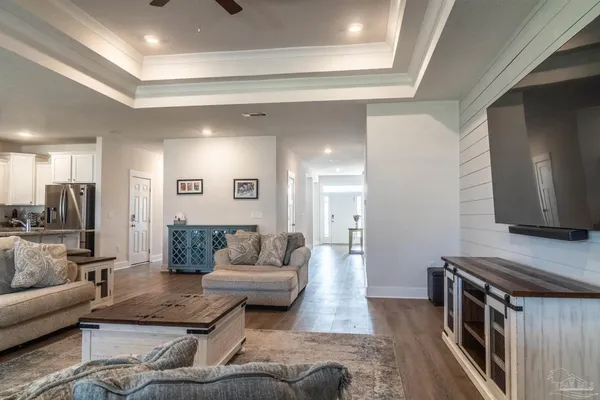 a living room with furniture and a wooden floor