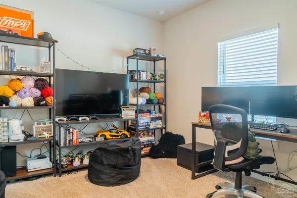 a view of a workspace with furniture and a window
