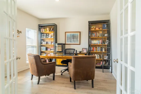 a view of a workspace with furniture and a window