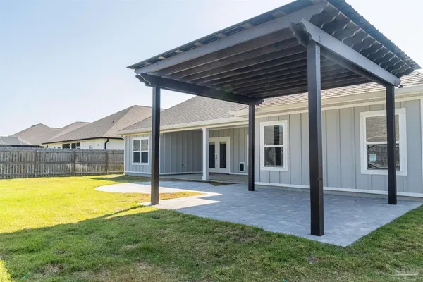 a swimming pool with outdoor seating and yard