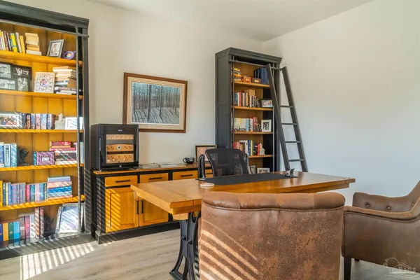 a room with furniture and book shelf