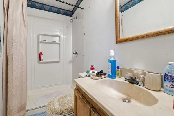 a bathroom with a sink vanity and a mirror